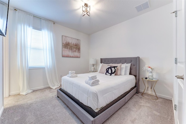 bedroom featuring light colored carpet