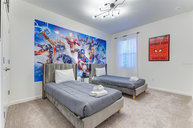 bedroom featuring a textured ceiling and light colored carpet