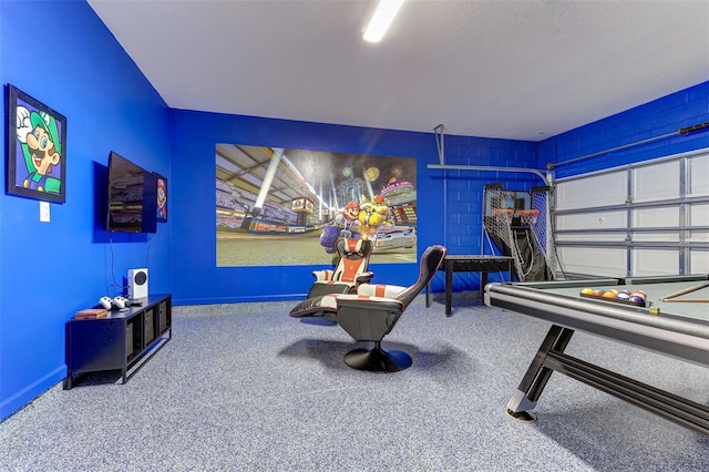 recreation room featuring a textured ceiling