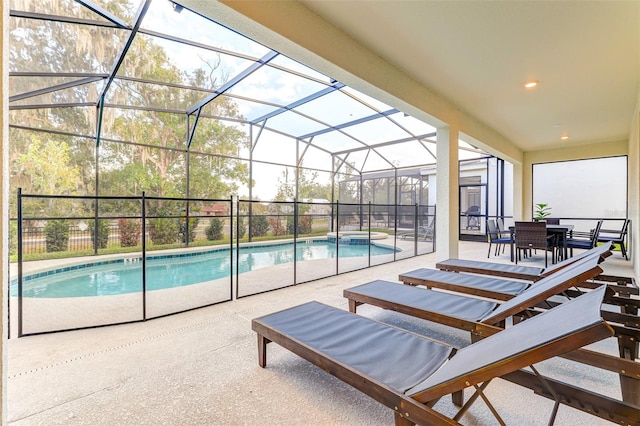 view of pool featuring glass enclosure and a patio