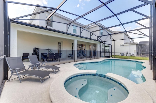 view of swimming pool with a lanai, an in ground hot tub, and a patio area