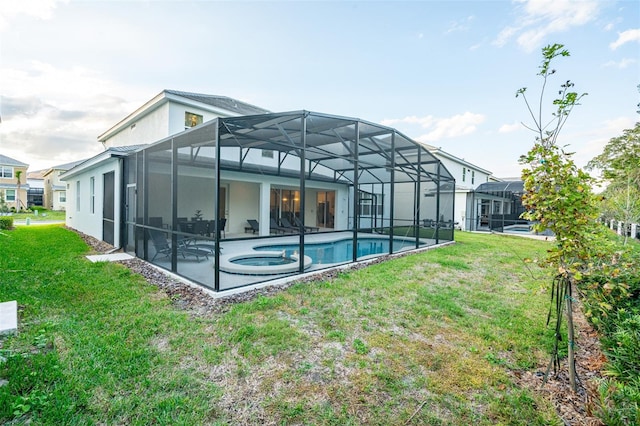 rear view of property featuring a swimming pool with hot tub, glass enclosure, and a yard