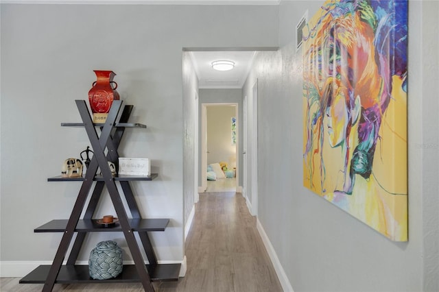 hallway featuring crown molding and wood-type flooring