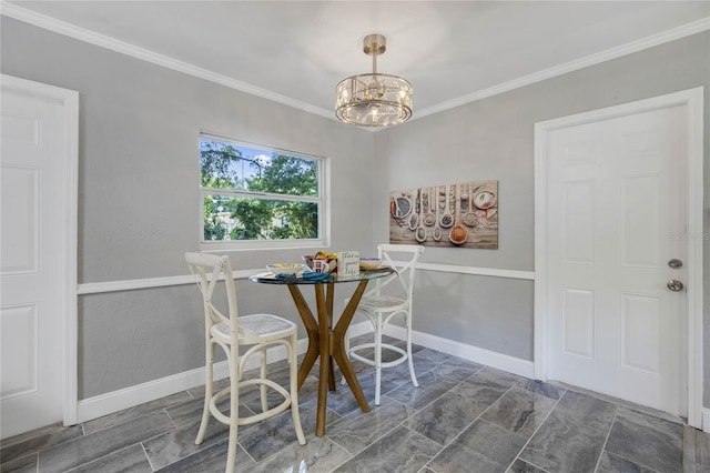 unfurnished dining area with ornamental molding, a chandelier, and dark tile patterned flooring