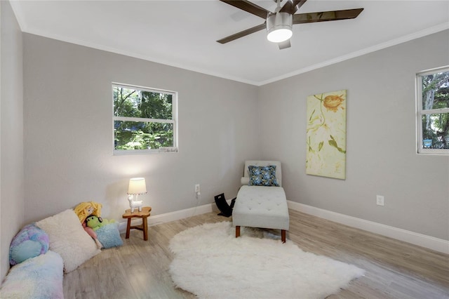 sitting room featuring plenty of natural light, ceiling fan, ornamental molding, and light hardwood / wood-style flooring