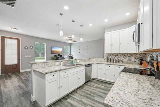 kitchen featuring light wood-type flooring, kitchen peninsula, sink, ceiling fan, and hanging light fixtures