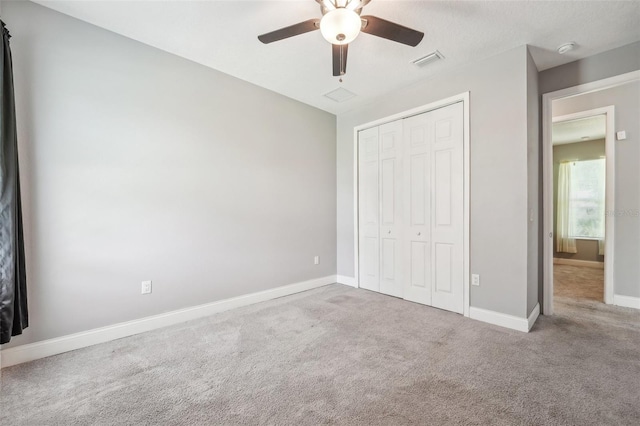 unfurnished bedroom featuring ceiling fan, a closet, and carpet floors