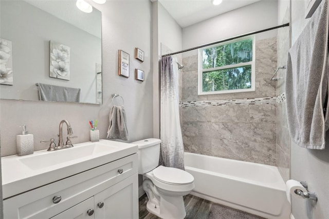 full bathroom featuring vanity, toilet, hardwood / wood-style floors, and shower / bath combo