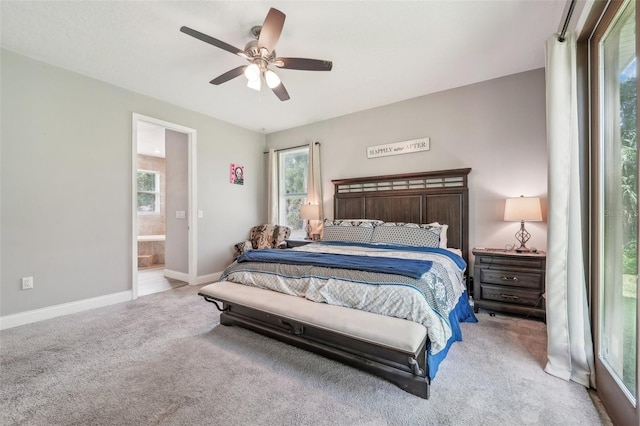 bedroom with light carpet, ensuite bathroom, and ceiling fan