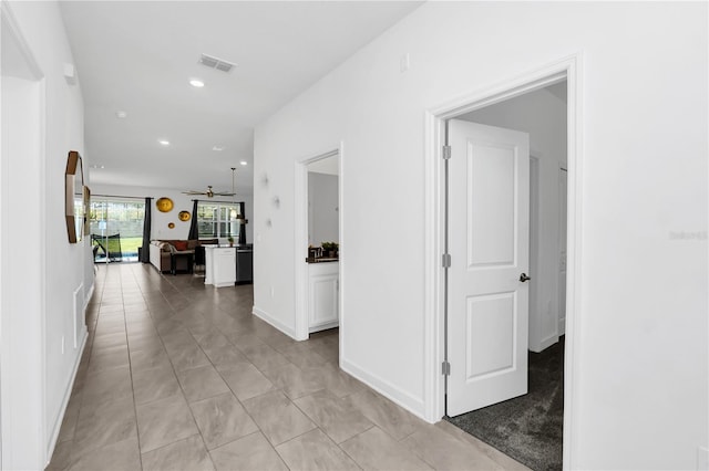 hallway featuring light tile patterned floors