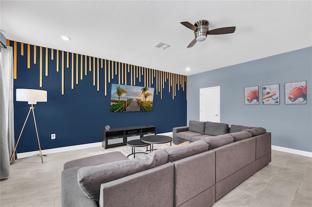 living room with ceiling fan and a textured ceiling