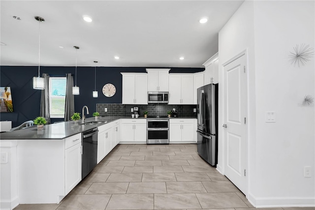 kitchen featuring hanging light fixtures, stainless steel appliances, sink, kitchen peninsula, and white cabinets