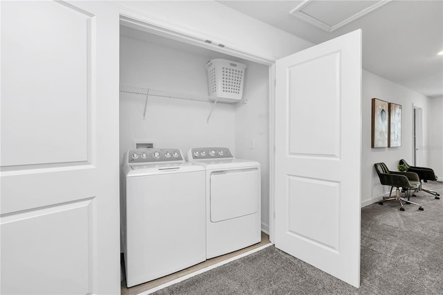 laundry room featuring washer and clothes dryer and light colored carpet