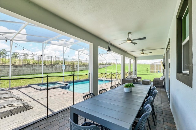 sunroom featuring ceiling fan