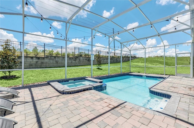 view of pool with an in ground hot tub, a lawn, and a patio