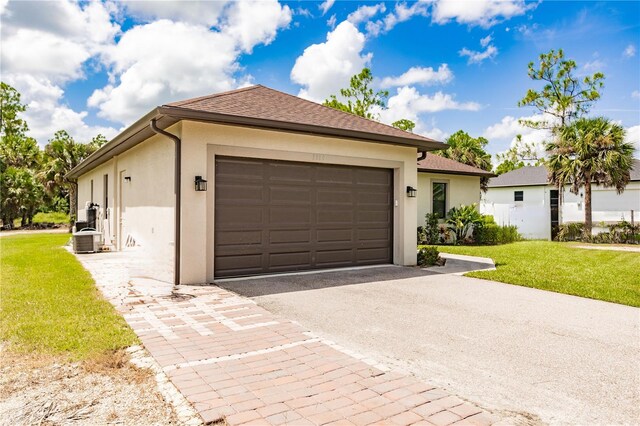 view of front of home featuring a garage and a front lawn