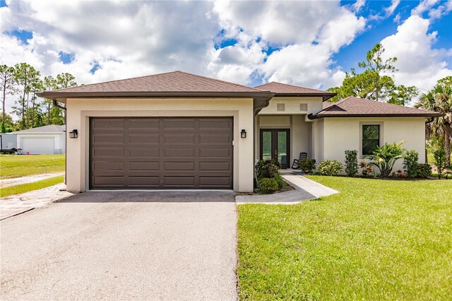 view of front of property featuring a front lawn and a garage