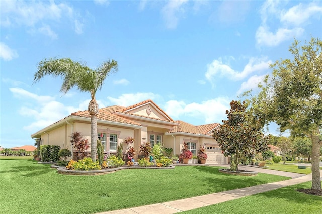 mediterranean / spanish-style home featuring a front lawn and a garage