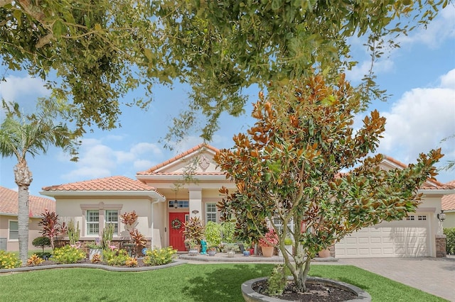 view of front of property with a garage and a front lawn