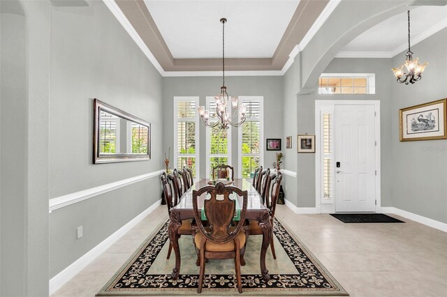 dining room featuring ornamental molding, plenty of natural light, a notable chandelier, and light tile patterned flooring