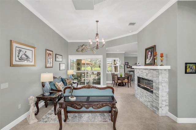 living room with a stone fireplace, light tile patterned floors, a notable chandelier, and ornamental molding