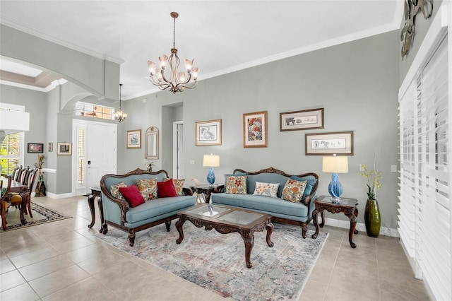 living room with ornamental molding, light tile patterned floors, and an inviting chandelier