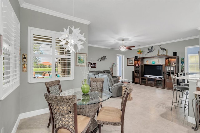 dining room with ceiling fan, ornamental molding, and light tile patterned floors