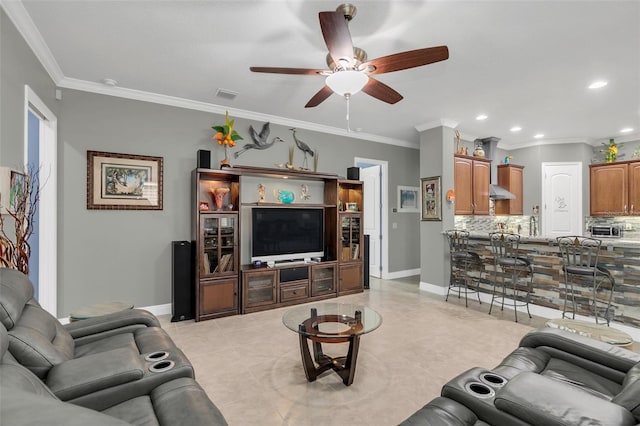 living room with ornamental molding, light tile patterned flooring, and ceiling fan