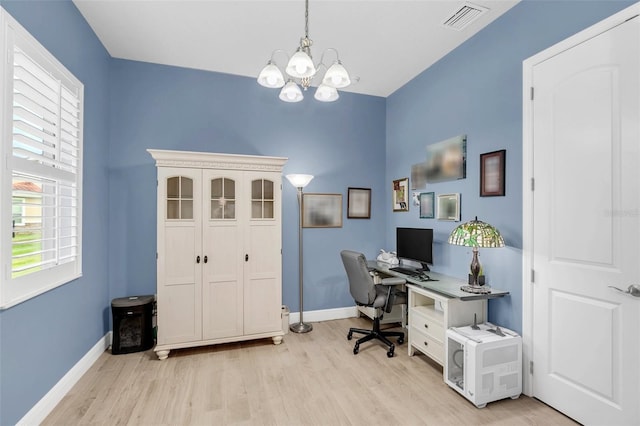 office with an inviting chandelier and light hardwood / wood-style floors