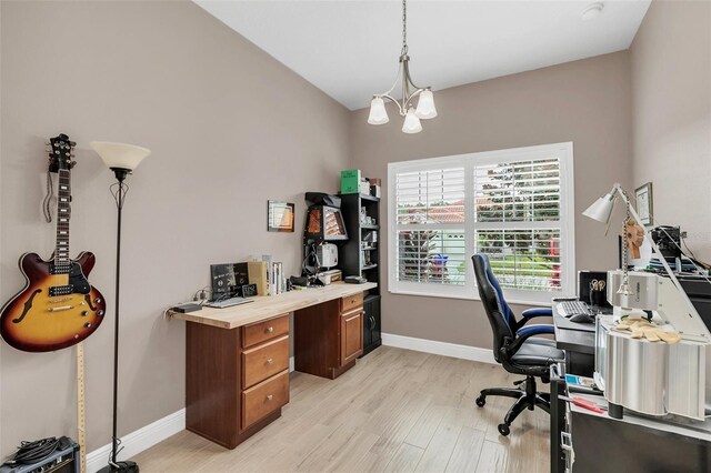 office space featuring light wood-type flooring and a chandelier