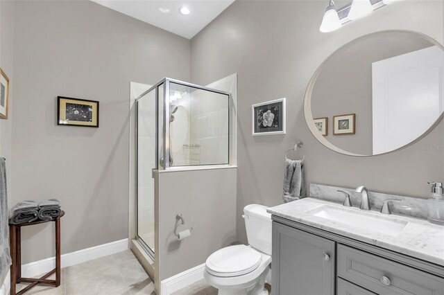 bathroom with vanity, toilet, a shower with shower door, and tile patterned flooring