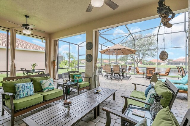 sunroom featuring ceiling fan