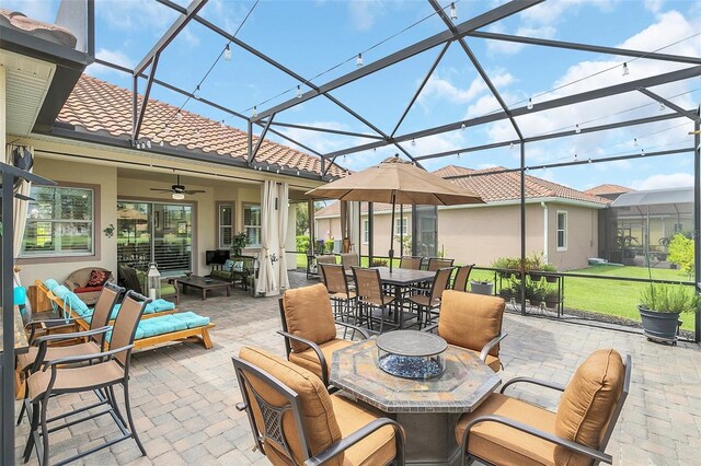 view of patio / terrace featuring an outdoor living space, a lanai, and ceiling fan