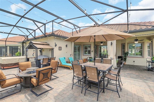 view of patio with ceiling fan and a lanai