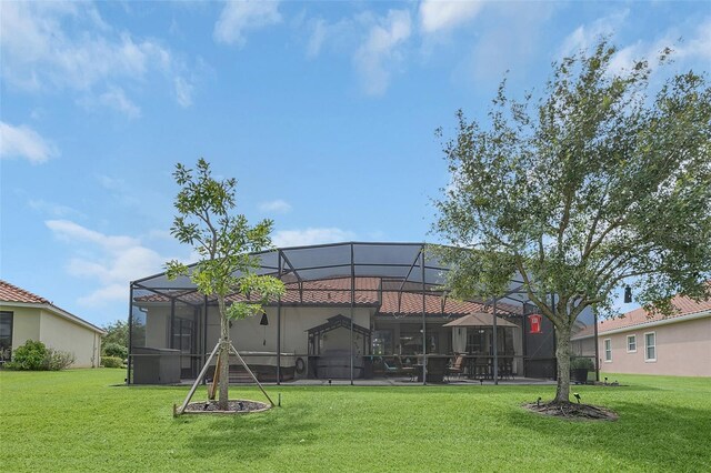 back of property featuring a lawn and a lanai