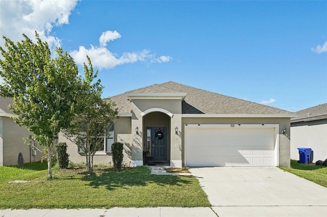 ranch-style house featuring a front lawn and a garage