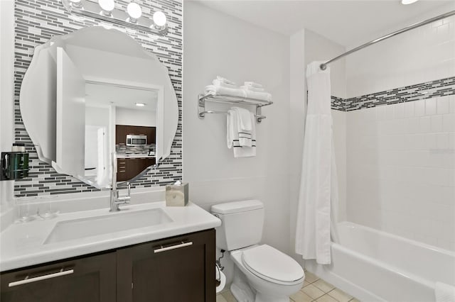 full bathroom with vanity, tasteful backsplash, toilet, tile patterned floors, and shower / bath combo