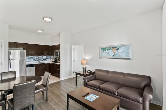 living room featuring light hardwood / wood-style flooring and sink