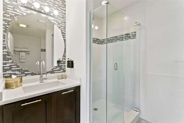 225 Celebration Pl Unit 427, Celebration, FL 34747 - bathroom with a shower stall, vanity, and decorative backsplash