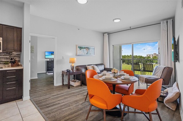 225 Celebration Pl Unit 427, Celebration, FL 34747 - dining area with light tile patterned floors and baseboards