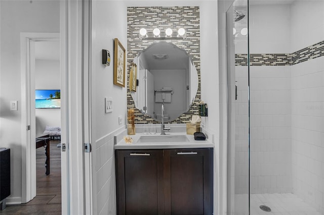 225 Celebration Pl Unit 427, Celebration, FL 34747 - full bath featuring a shower stall, vanity, tile walls, connected bathroom, and wood finished floors