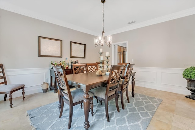 dining room featuring ornamental molding and an inviting chandelier