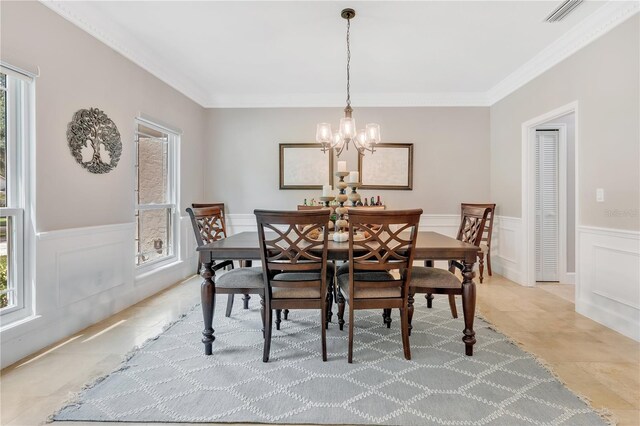 dining space with a wealth of natural light, crown molding, and a chandelier