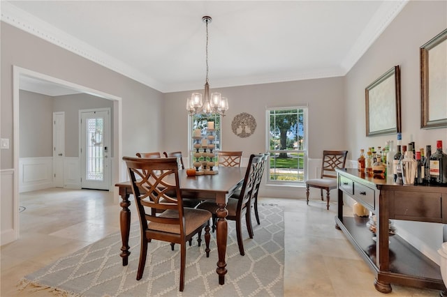 dining room featuring ornamental molding and an inviting chandelier