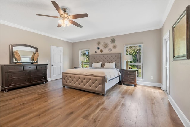 bedroom with ceiling fan, crown molding, and light wood-type flooring