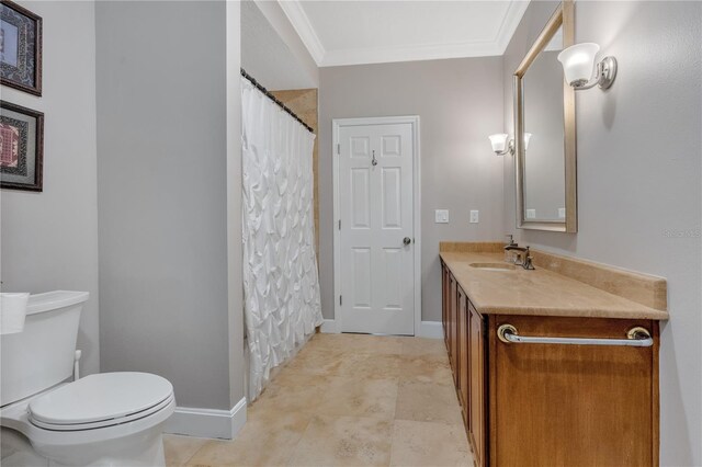 bathroom featuring vanity, toilet, and ornamental molding