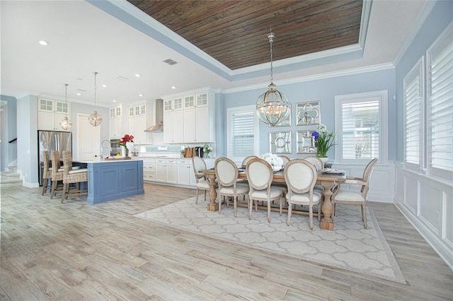 dining space with a chandelier, light hardwood / wood-style flooring, plenty of natural light, and ornamental molding