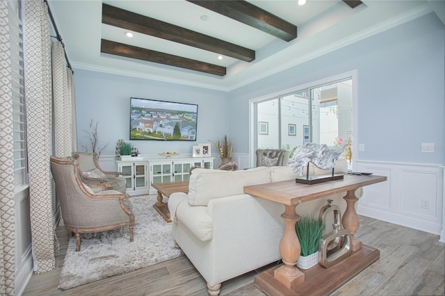 living room with crown molding, beamed ceiling, and light wood-type flooring