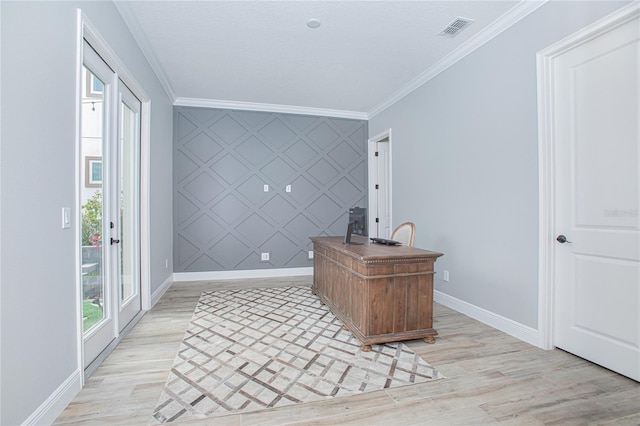 home office with a textured ceiling, light wood-type flooring, and ornamental molding