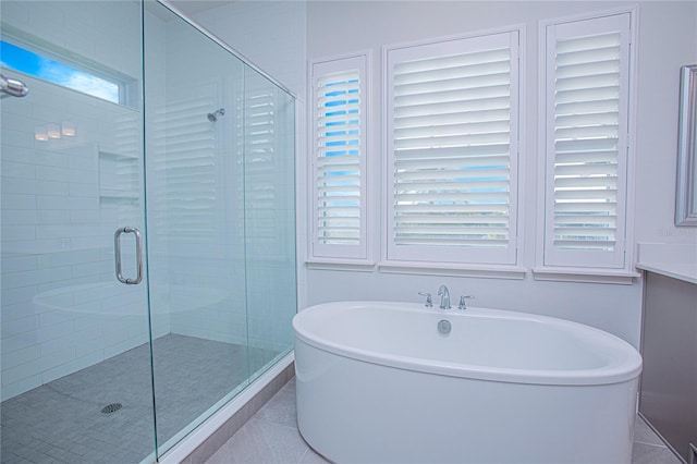 bathroom with tile patterned floors and independent shower and bath